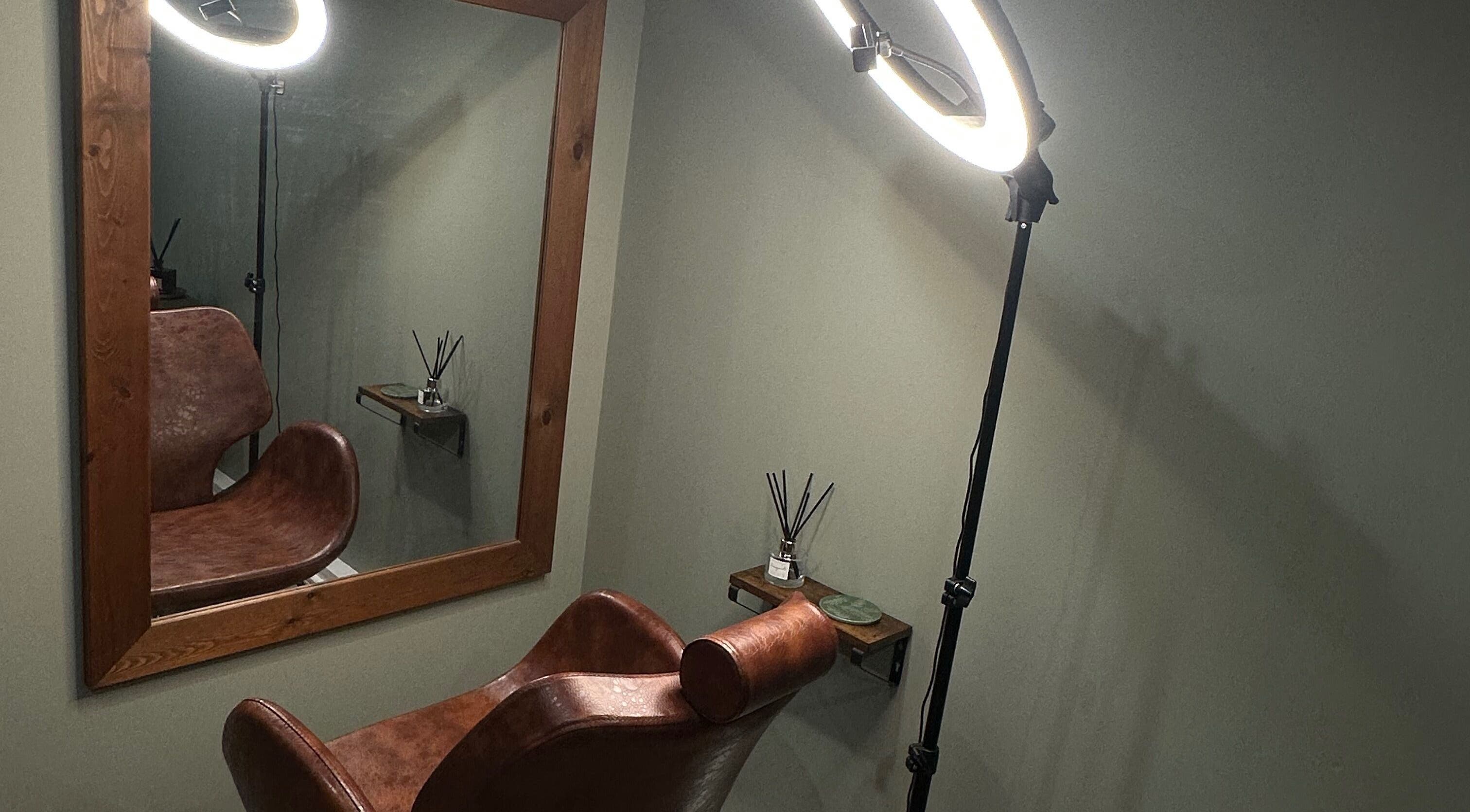 Stylish hair styling station at AJ Beauty Studio, Hucknall, England, GB, featuring a leather chair and mirror.