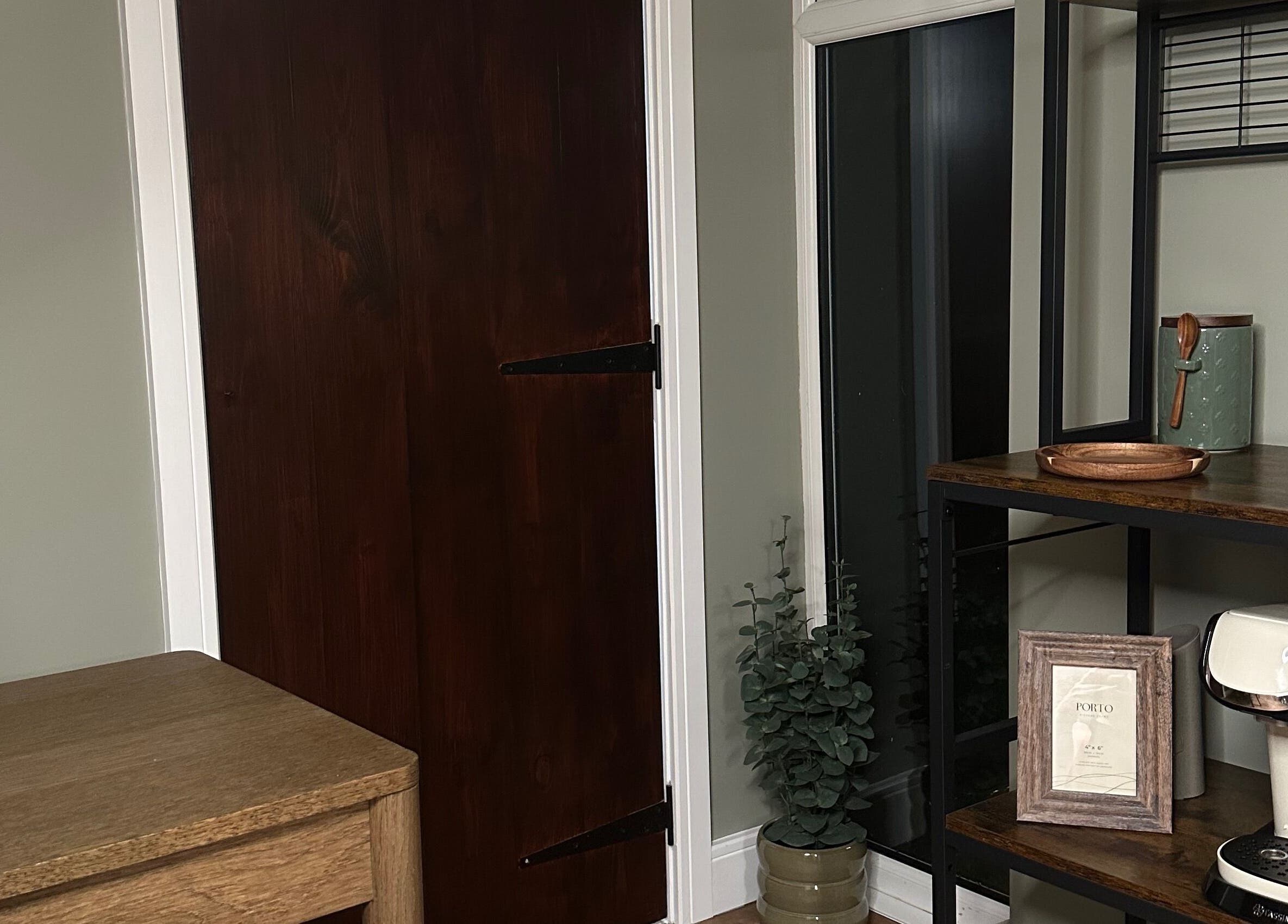 Warm corner setup at AJ Beauty Studio, Hucknall, England, GB with wooden door and decorative shelving.