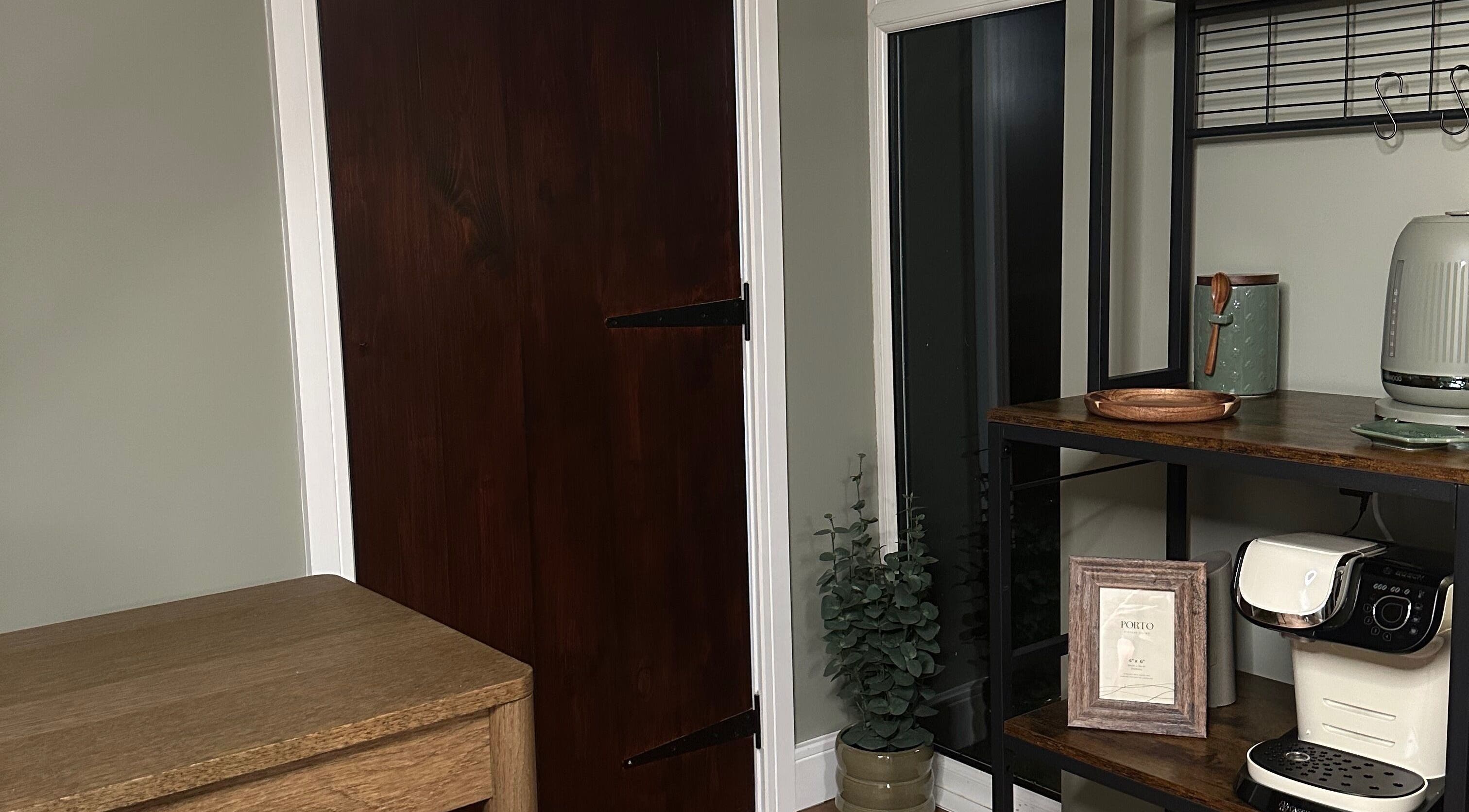 Warm corner setup at AJ Beauty Studio, Hucknall, England, GB with wooden door and decorative shelving.