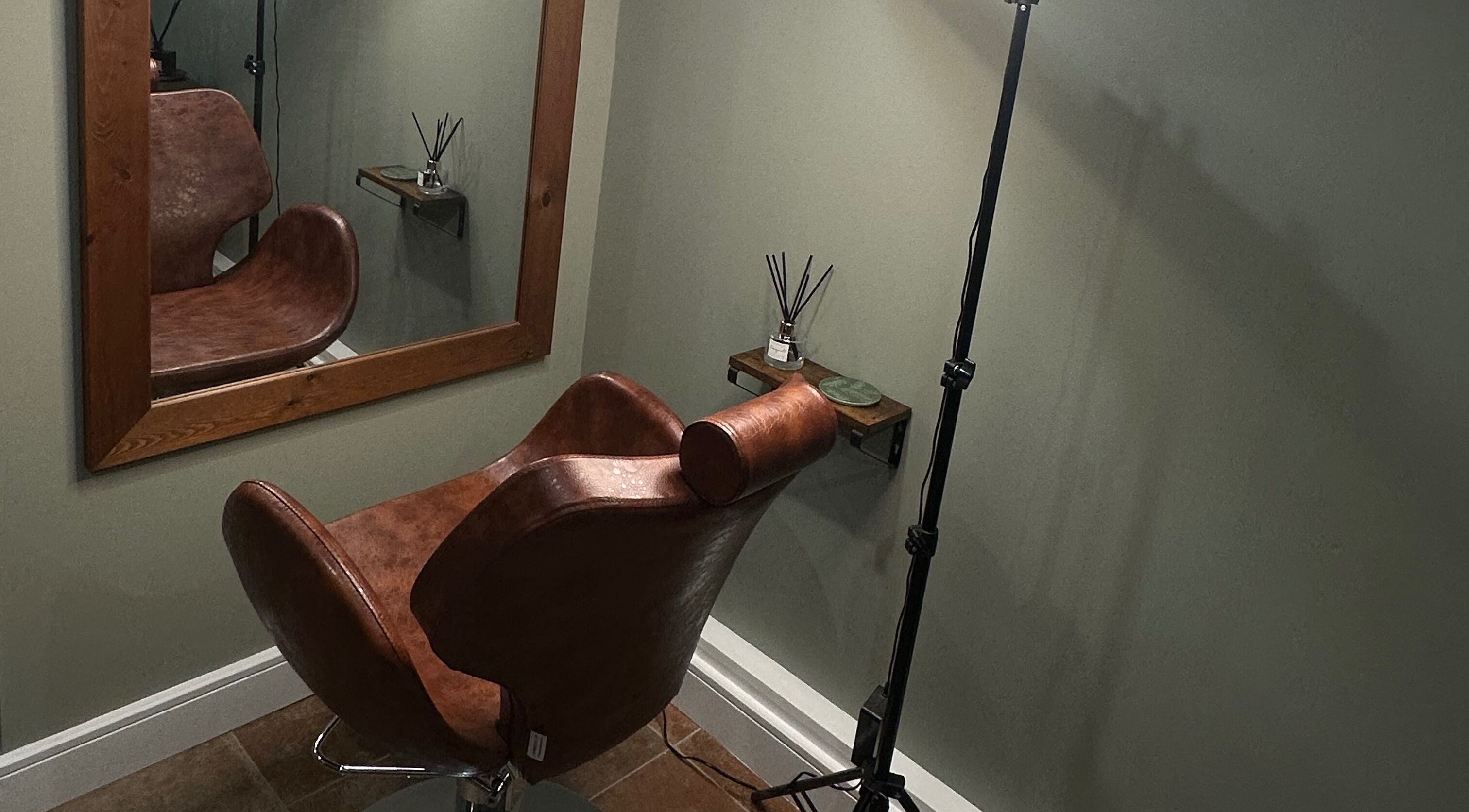AJ Beauty Studio / The Skin Salon in Hucknall, England, GB features a stylish, cozy salon corner with a leather chair.