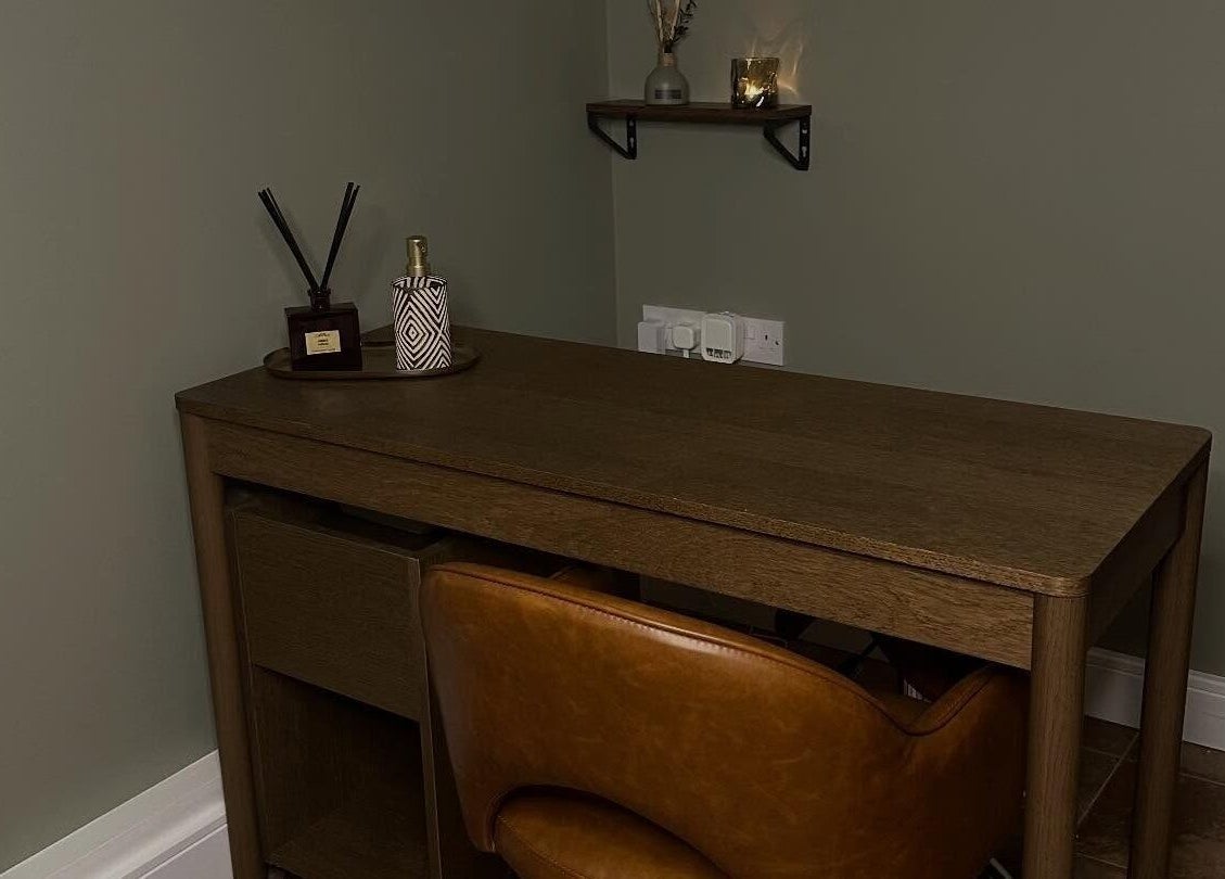 Elegant brown desk with decor in AJ Beauty Studio, Hucknall, England, GB. A cozy and inviting workspace.