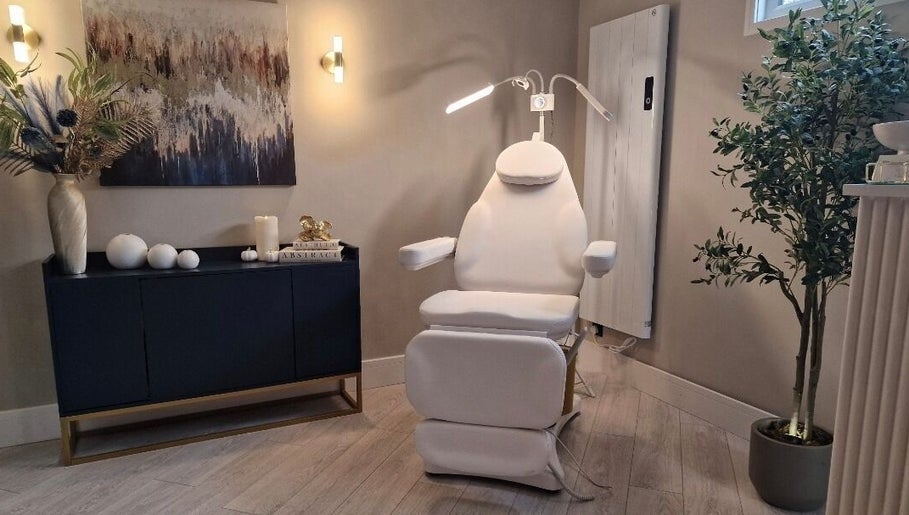 Cozy treatment room at Aesthetics Fifty Five, Wakefield, England, GB, featuring a modern white chair.