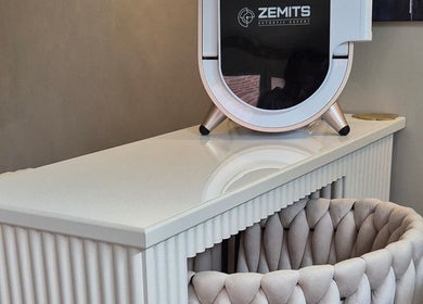 Sleek skincare device at Aesthetics Fifty Five in Wakefield, England, GB, on a modern white console.