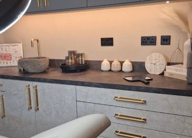 Aesthetic treatment room at Aesthetics Fifty Five, Wakefield, England, GB with modern decor and soft lighting.