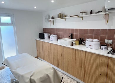 Sugared by Shola's calming treatment room in Bristol, England, GB, featuring modern decor and wellness amenities.