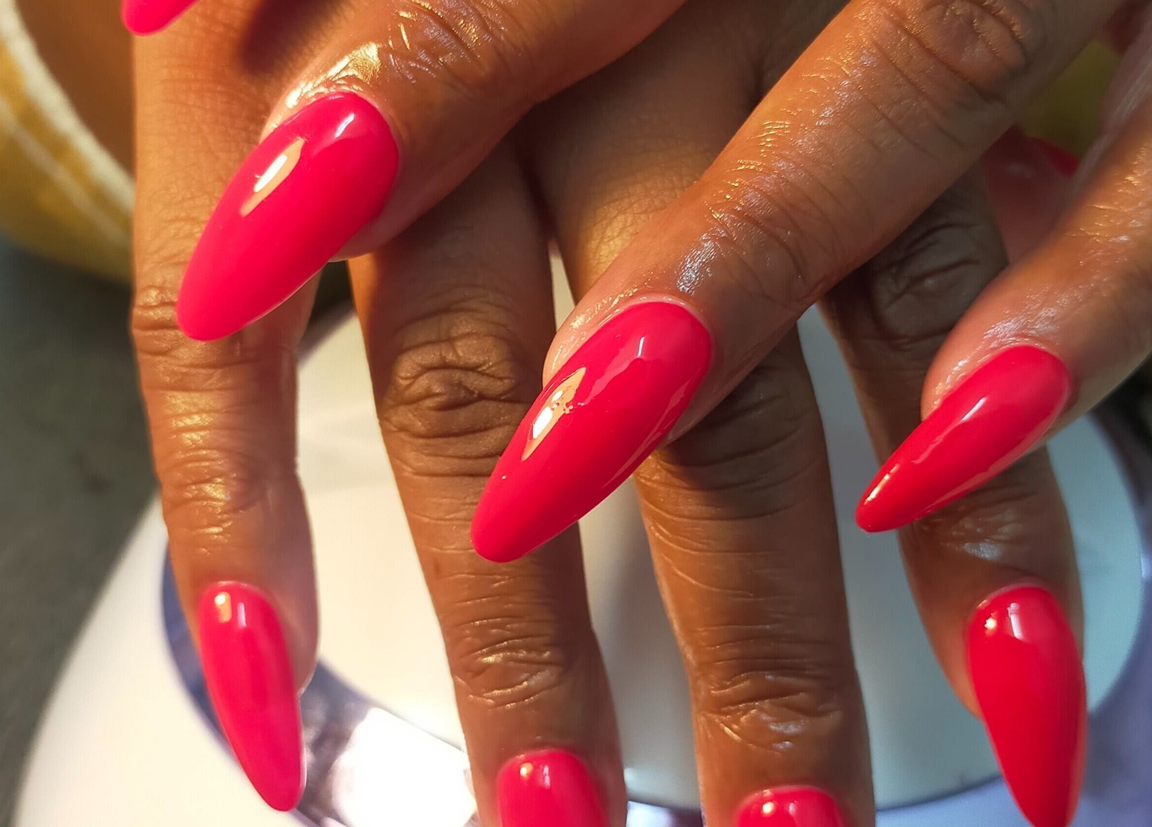 Bright pink manicure at HD Beauty Parlor in Cape Town, Western Cape, ZA showcases nail artistry.