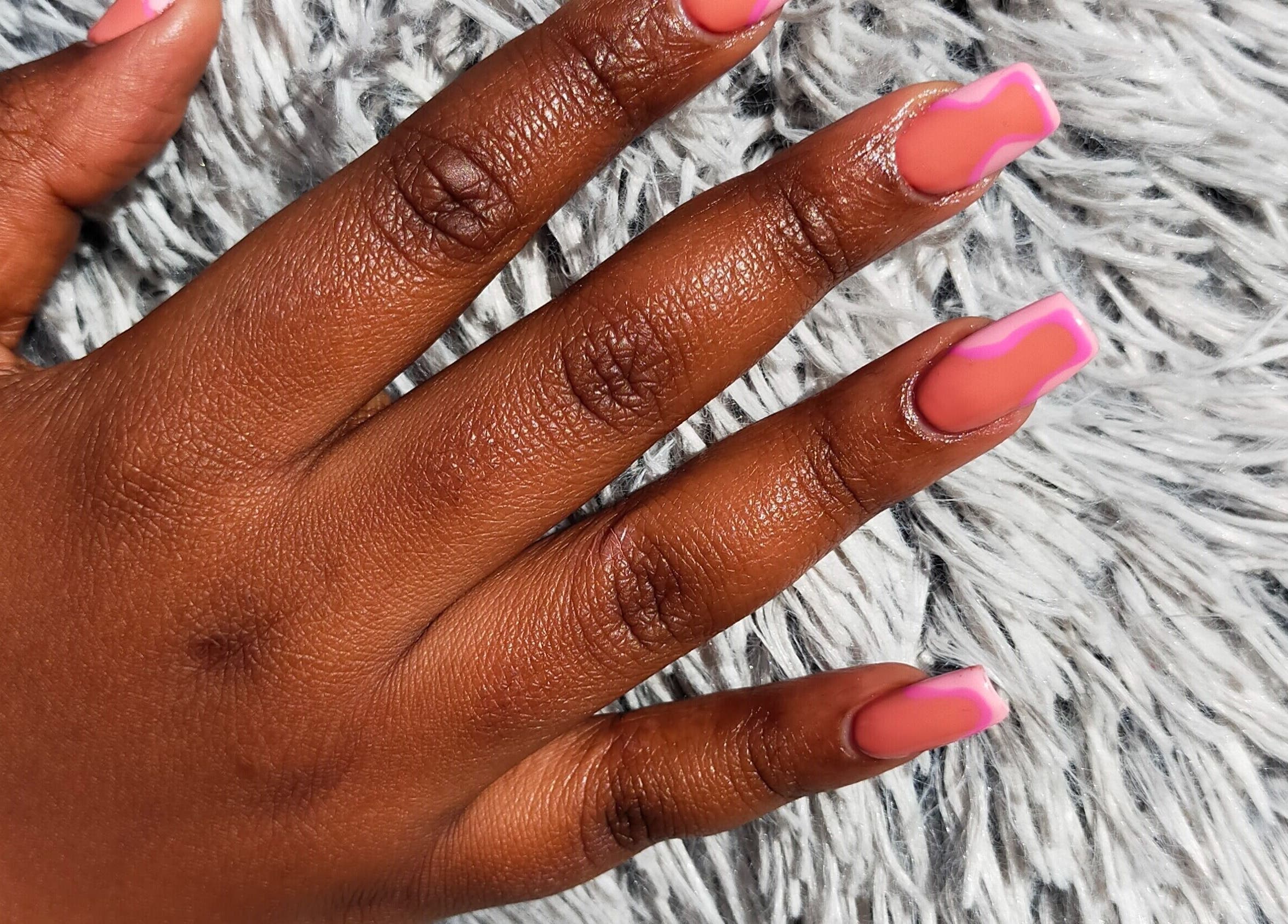 HD Beauty Parlor in Cape Town offers vibrant nail art on manicured hand, Western Cape, ZA.