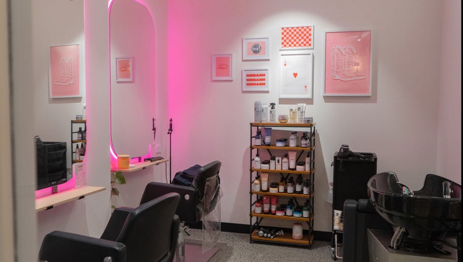 Chic interior of Maddi Jane Hair Studio in Southport, Queensland, AU with pink lighting and modern decor.