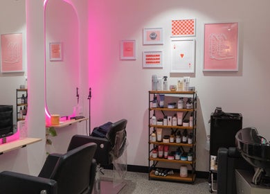 Chic interior of Maddi Jane Hair Studio in Southport, Queensland, AU with pink lighting and modern decor.