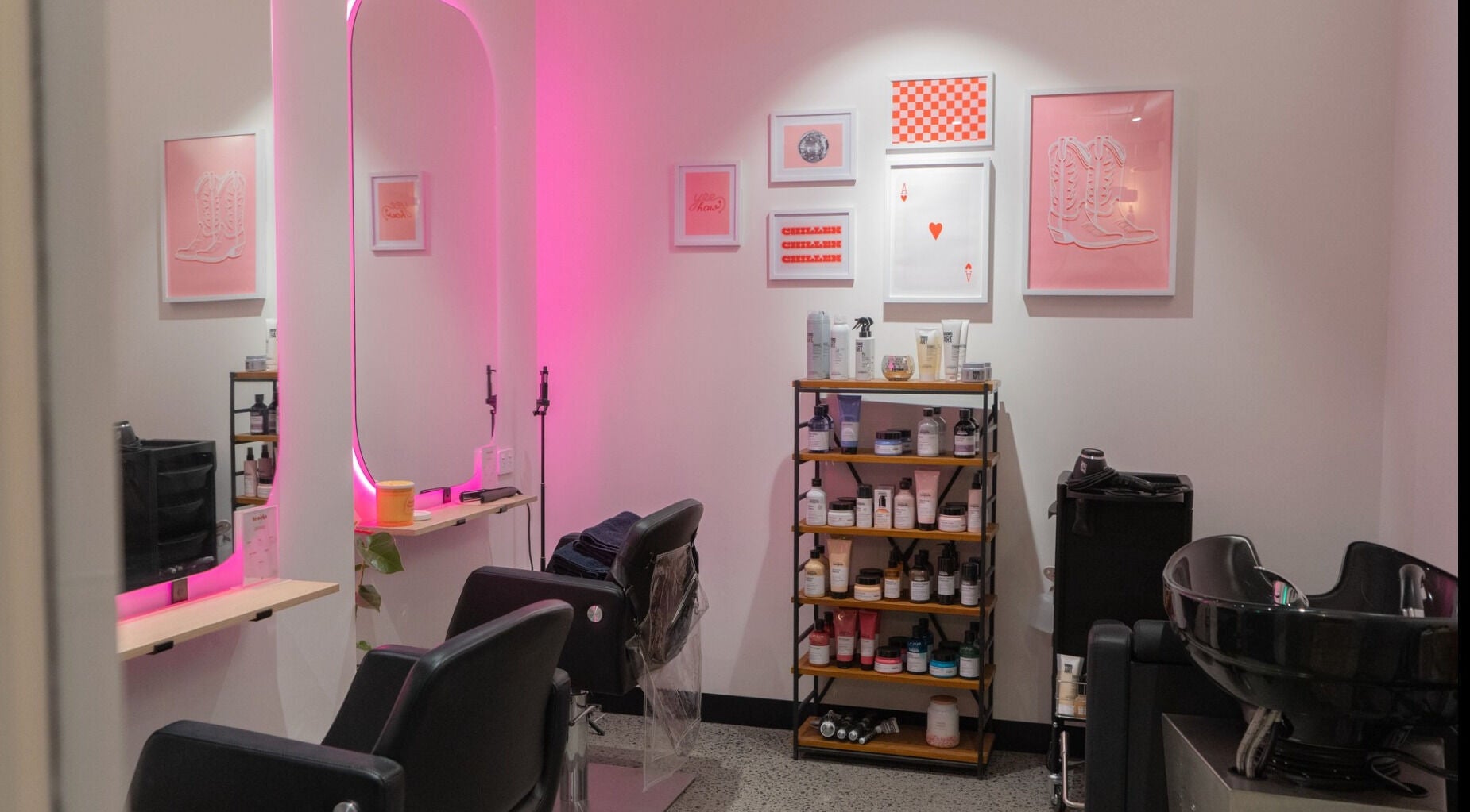 Chic interior of Maddi Jane Hair Studio in Southport, Queensland, AU with pink lighting and modern decor.