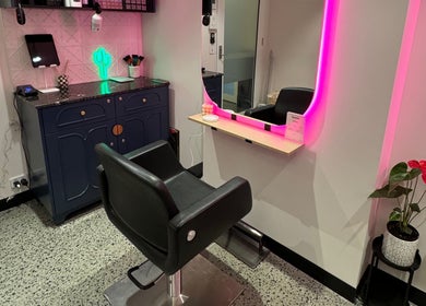 Modern styling station at Maddi Jane Hair Studio in Southport, Queensland, AU, features neon lighting and chic decor.