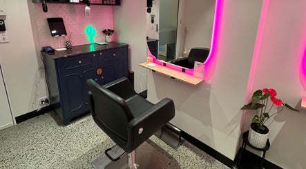 Modern styling station at Maddi Jane Hair Studio in Southport, Queensland, AU, features neon lighting and chic decor.