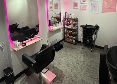 Modern salon setup at Maddi Jane Hair Studio, Southport, Queensland, AU, featuring a stylish mirror and seating.