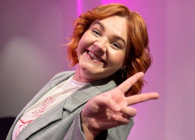 Smiling person at Maddi Jane Hair Studio in Southport, Queensland, AU, showing a peace sign.