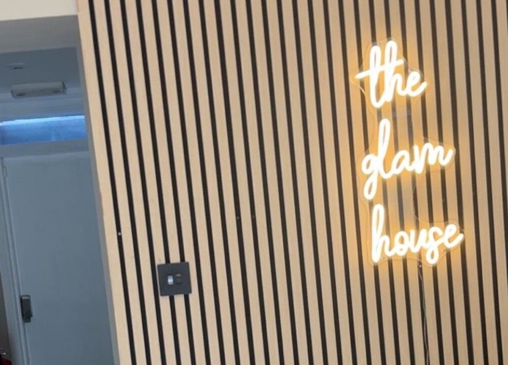 Neon sign on striped wall at Envision Aesthetics (Edinburgh), Edinburgh, Scotland, GB.