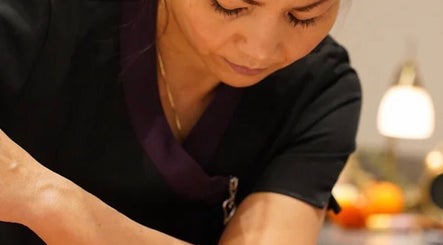 Therapist providing massage at Thawee Thai Therapy in Shirley, England, GB. Relaxation and wellness focus.