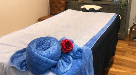 Relaxing spa table with blue towels and red rose at Thawee Thai Therapy, Shirley, England, GB.