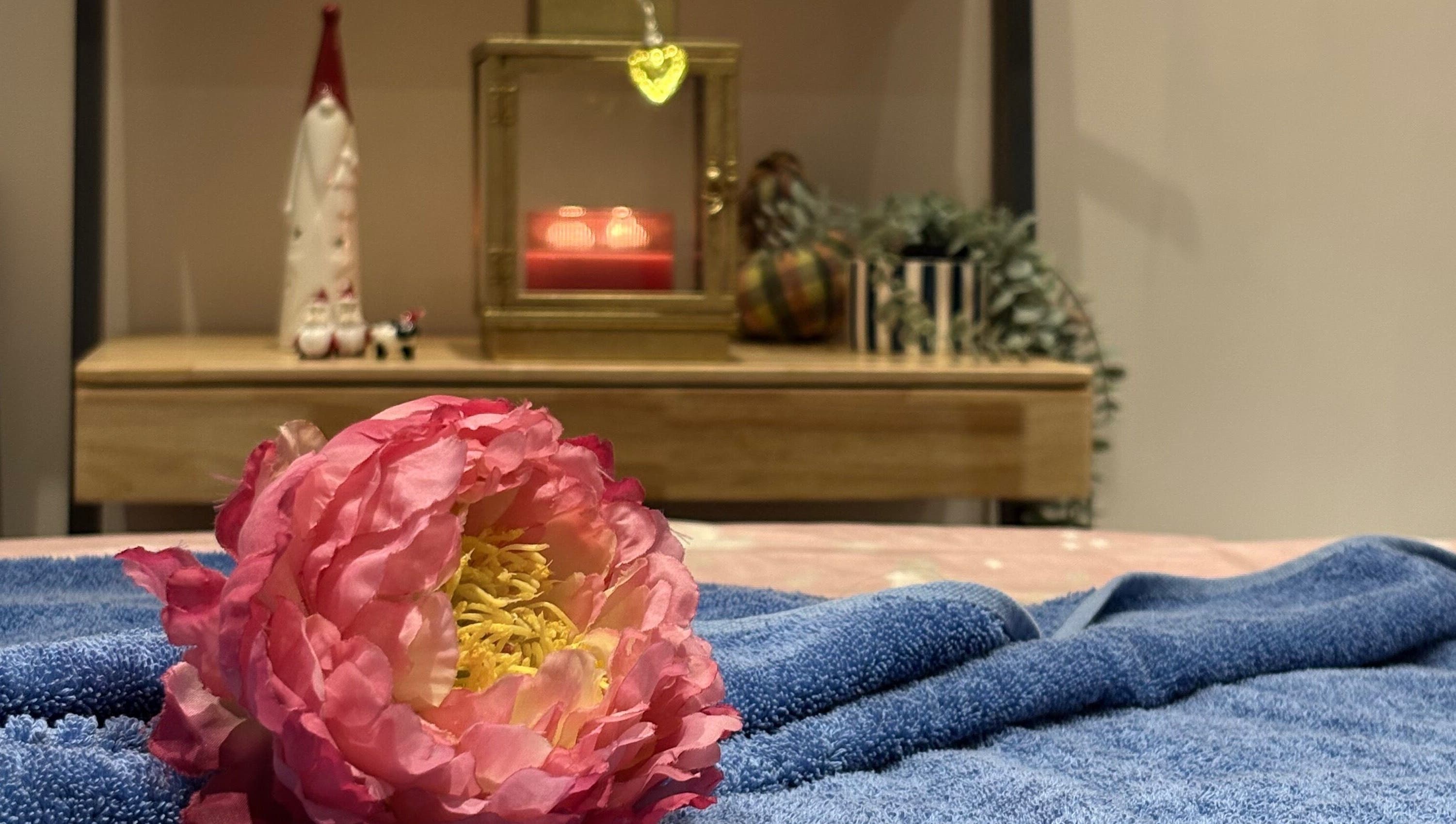 Elegant pink flower on a towel at Thawee Thai Therapy, Solihull, England, GB, creating a tranquil ambiance.