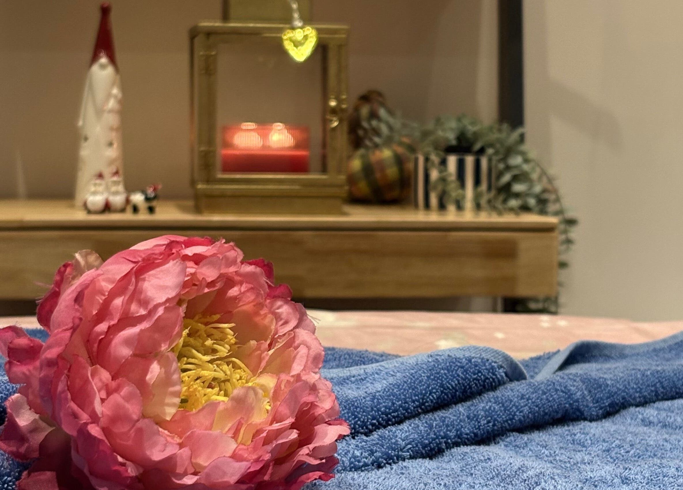 Elegant pink flower on a towel at Thawee Thai Therapy, Solihull, England, GB, creating a tranquil ambiance.