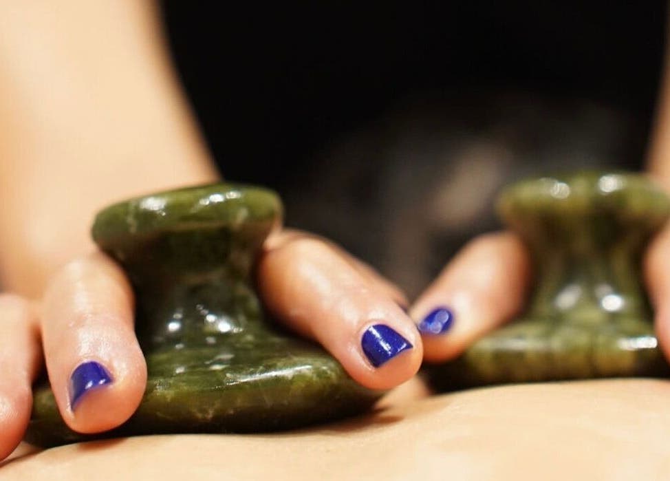 Hands holding hot stone at Thawee Thai Therapy, Solihull, England, GB, showcasing a relaxing massage treatment.