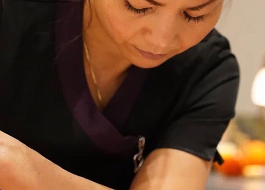 Massage therapist at Thawee Thai Therapy in Solihull, England providing soothing treatment.