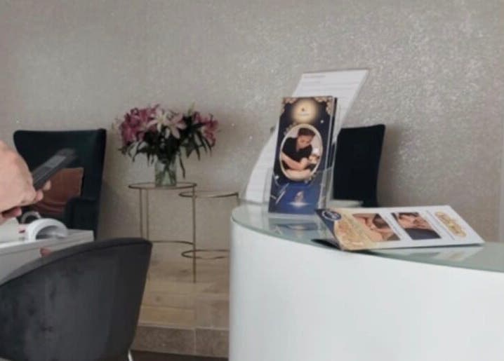 Reception area at Thawee Thai Therapy in Solihull, England, GB, featuring brochures and floral decor.