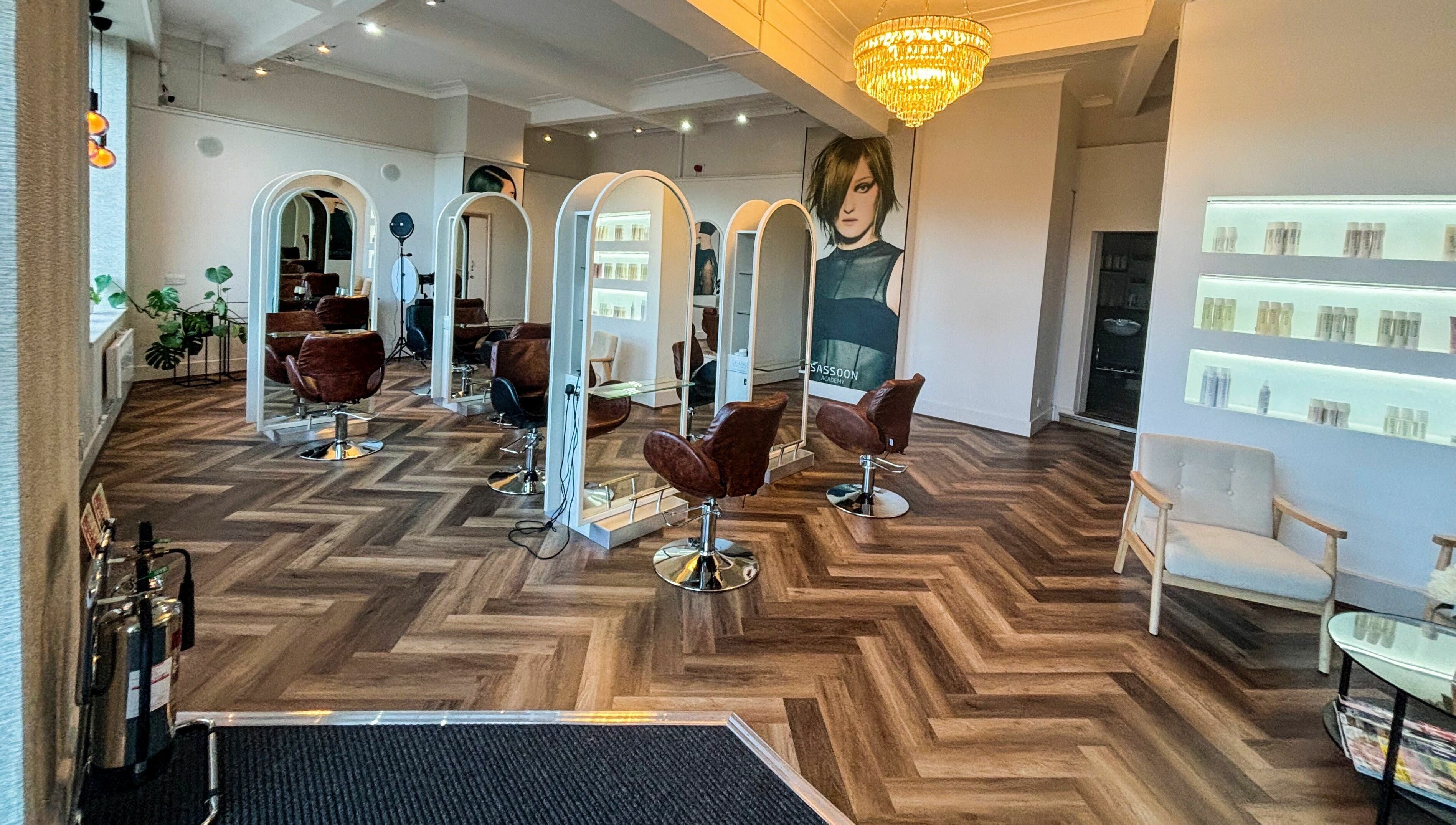 Stylish interior of Nathan Richardson Hair salon in Sheffield, England, GB with elegant chairs and mirrors.