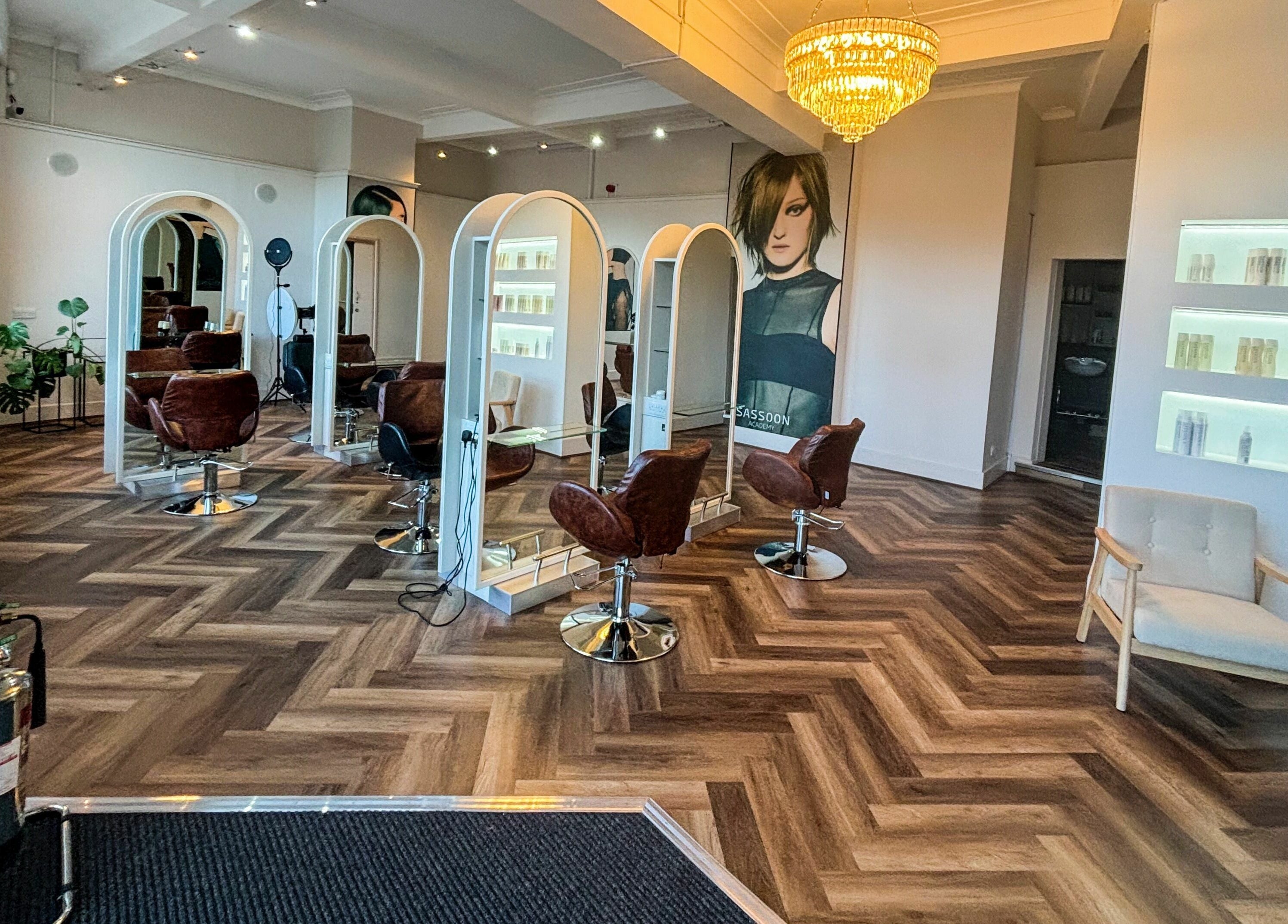 Stylish interior of Nathan Richardson Hair salon in Sheffield, England, GB with elegant chairs and mirrors.