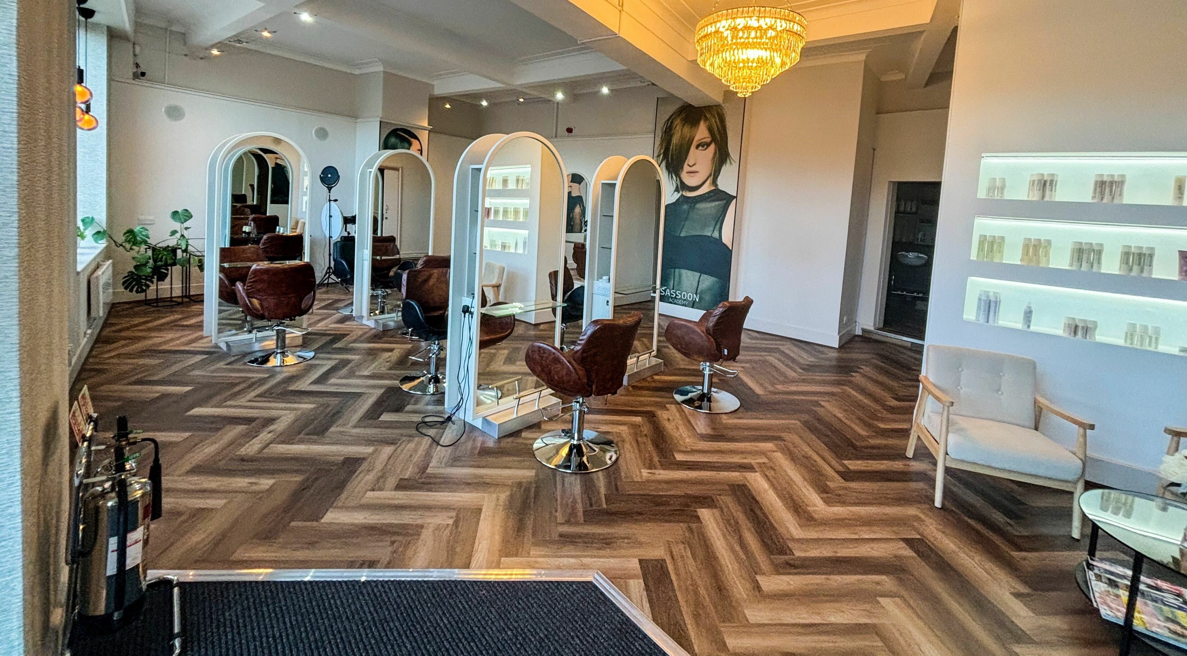 Stylish interior of Nathan Richardson Hair salon in Sheffield, England, GB with elegant chairs and mirrors.