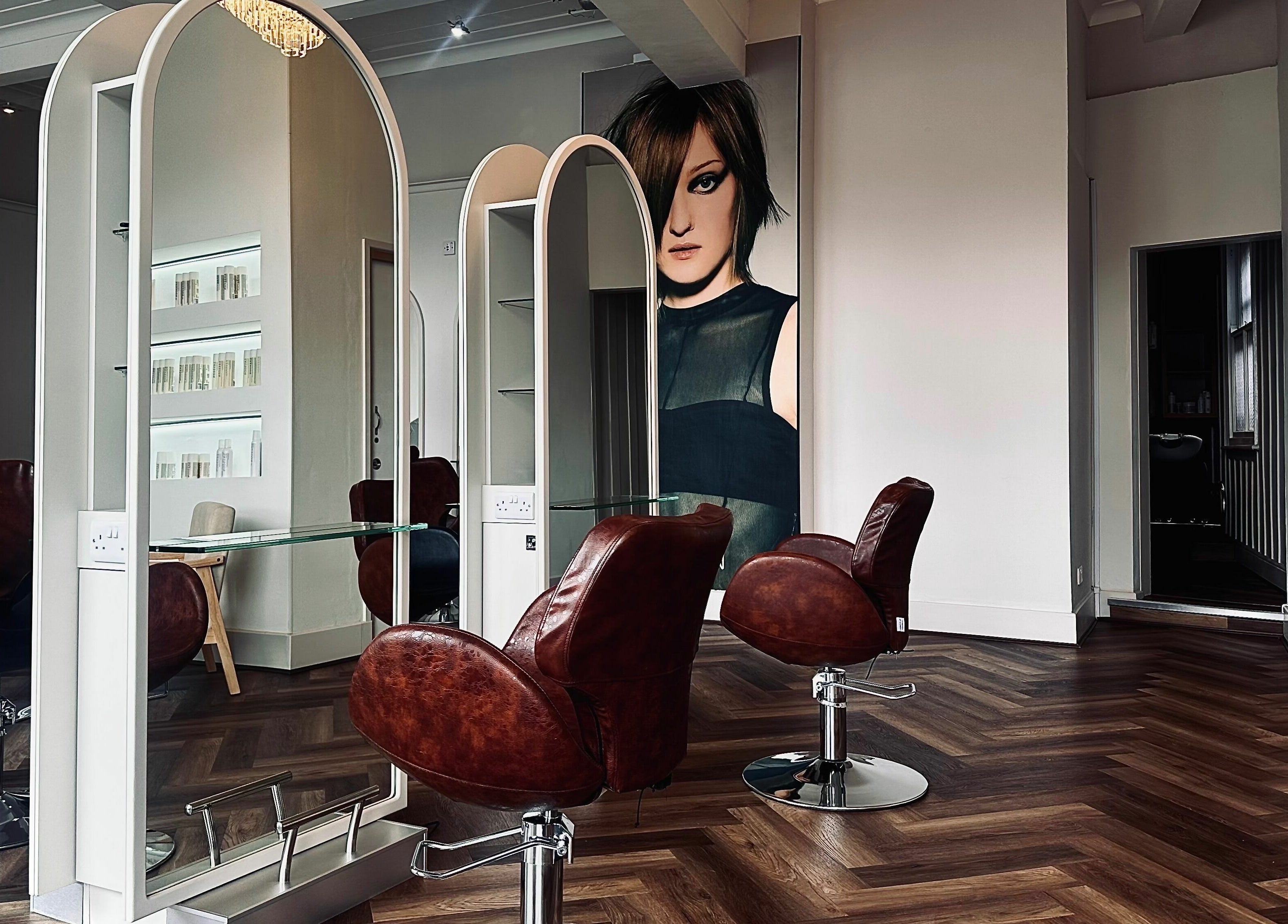 Modern interior of Nathan Richardson Hair, Sheffield, England, GB with stylish chairs and mirrors.