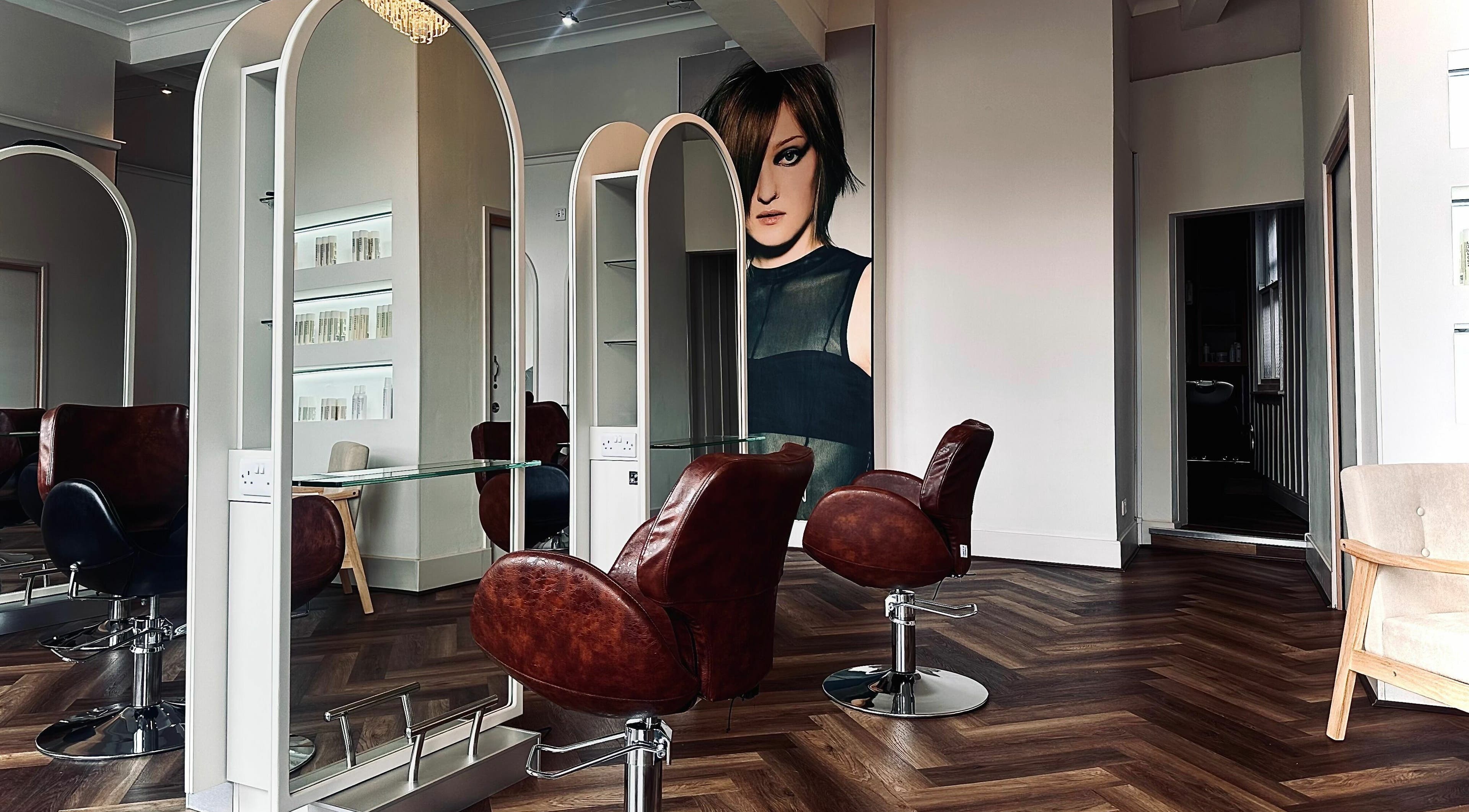 Modern interior of Nathan Richardson Hair, Sheffield, England, GB with stylish chairs and mirrors.