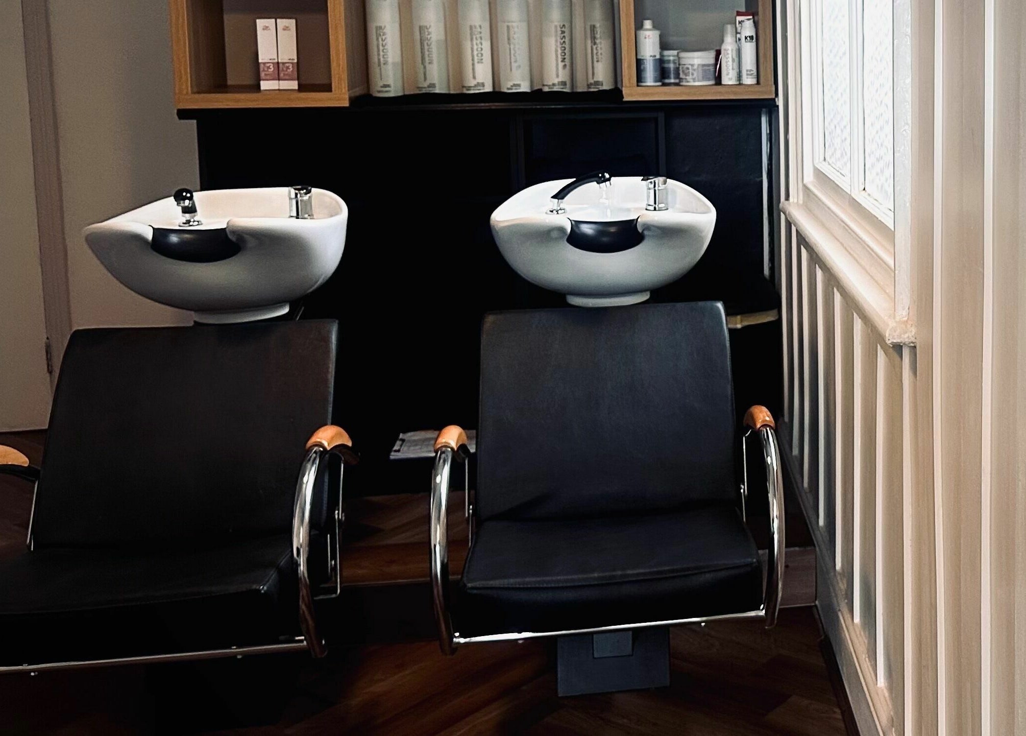 Chic wash stations at Nathan Richardson Hair, Sheffield, England, GB, set in a modern interior.