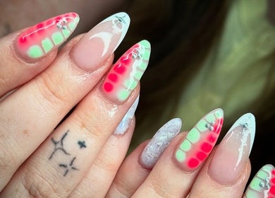 Vibrant neon nail art with gems at Cw Artistry, Glasgow, Scotland, GB.