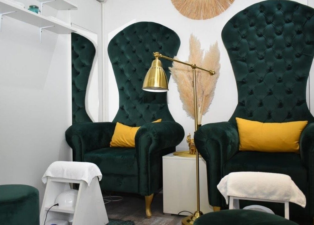Luxurious seating area at Kalisi, Београд, RS offers plush comforts for beauty treatments.