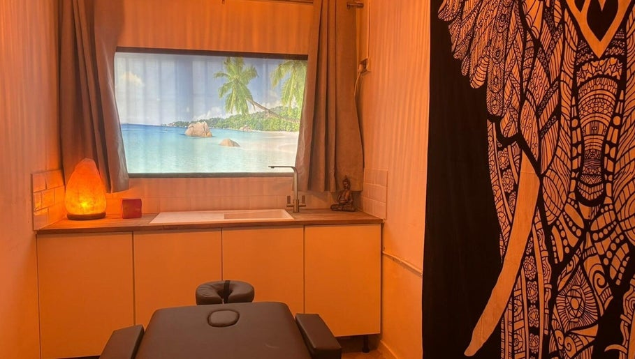 Tranquil massage room at Wellness at Happy Buddha, Poole, England, GB with ocean window view and Buddha statue.