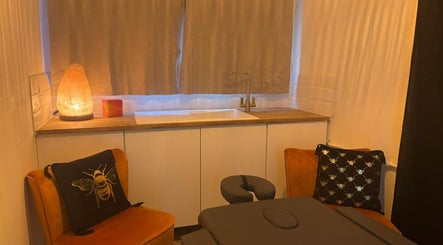 Tranquil massage room at Wellness at Happy Buddha, Poole, England, GB with elegant decor and soft lighting.