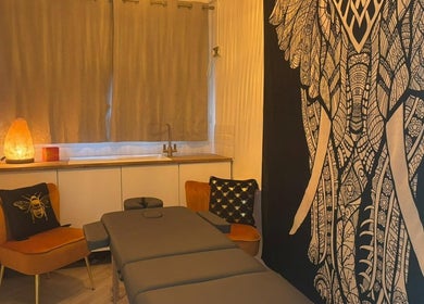Tranquil massage room at Wellness at Happy Buddha, Poole, England, GB, featuring cozy decor and soft lighting.