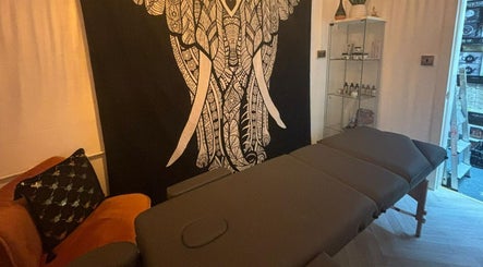 Relaxing massage room at Wellness at Happy Buddha in Poole, England, GB featuring an elephant tapestry.