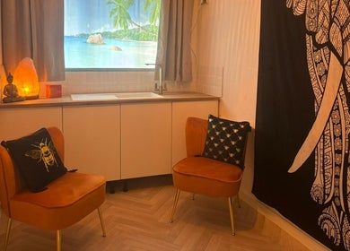 Cozy seating area with Buddha decor at Wellness at Happy Buddha, Poole, England, GB.