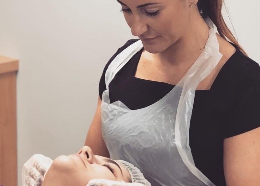 Facial treatment at Unique Beauty and Aesthetics in Chorley, England, GB. A beautician attends to a client's skin.