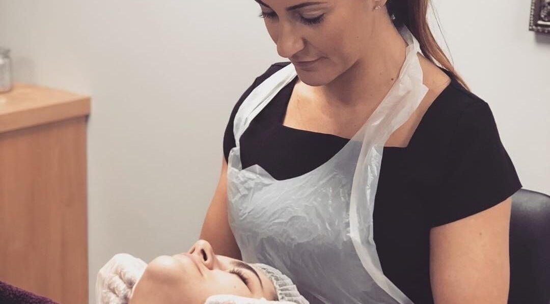 Facial treatment at Unique Beauty and Aesthetics in Chorley, England, GB. A beautician attends to a client's skin.