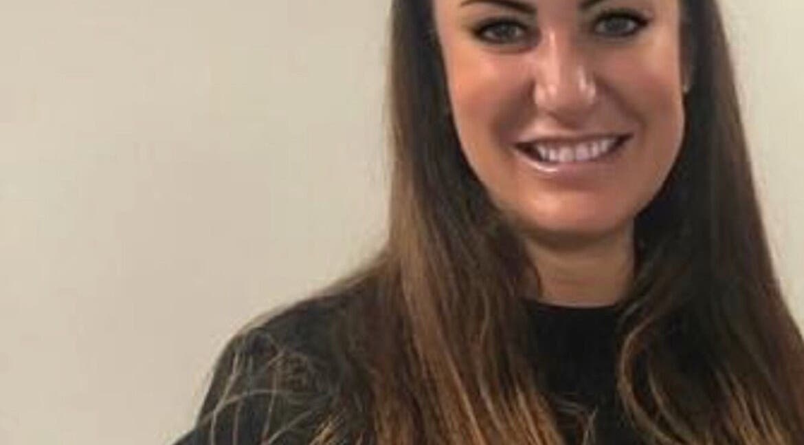 Friendly team member at Unique Beauty and Aesthetics, Chorley, England, GB, welcoming clients with a smile.