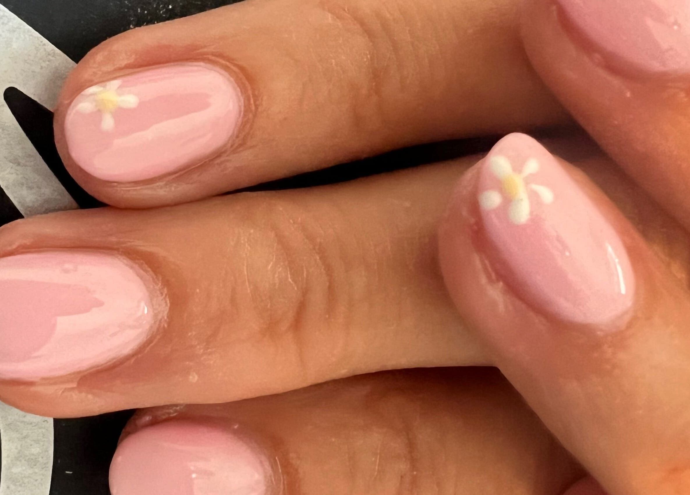 Elegant pink nails with floral design at Unique Beauty and Aesthetics, Chorley, England, GB.