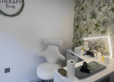 Therapy Beauty's cozy nail station in Wakefield, England, GB, with a chic chair and a floral backdrop.