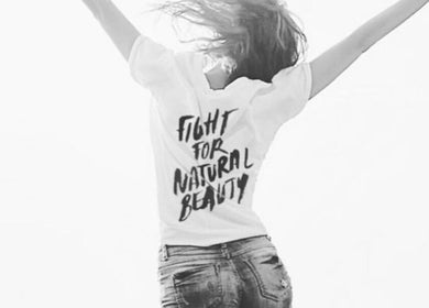 Woman in a T-shirt with 'Fight for Natural Beauty' at Melbourne Endermologie - Armadale, Melbourne, Victoria, AU.