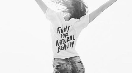 Woman in a T-shirt with 'Fight for Natural Beauty' at Melbourne Endermologie - Armadale, Melbourne, Victoria, AU.
