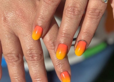 Vibrant ombre orange to yellow nails at Elizabeth Joel Nail Artistry, Cape Town, Western Cape, ZA.
