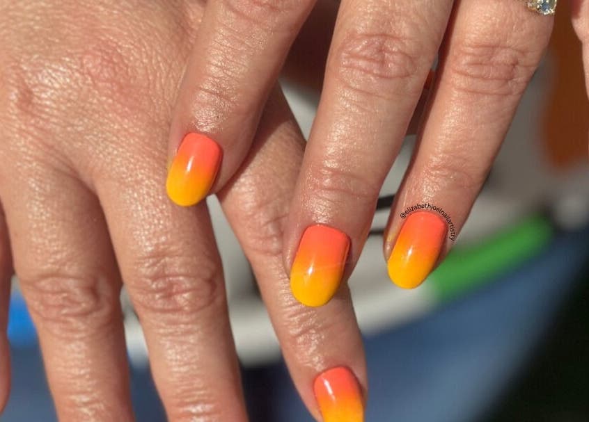 Vibrant sunset-themed nails by Elizabeth Joel Nail Artistry in Cape Town, Western Cape, ZA.