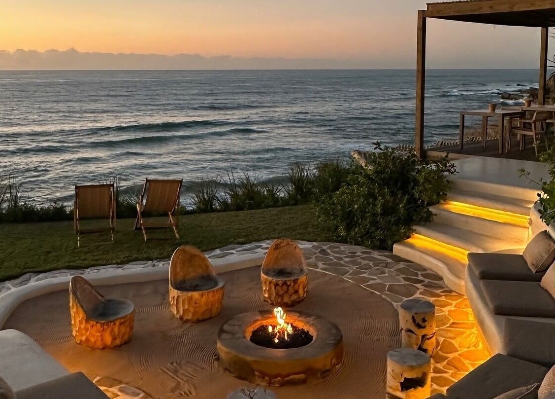 Tranquil sunset view at Sala Beach Spa, Dolphin Coast, KwaZulu-Natal, ZA, with cozy seating and oceanfront fire pit.