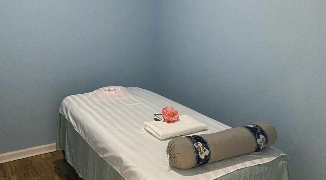 Tranquil massage room at Float & Massage Chesapeake in Chesapeake, Virginia, US with a rose and towel.